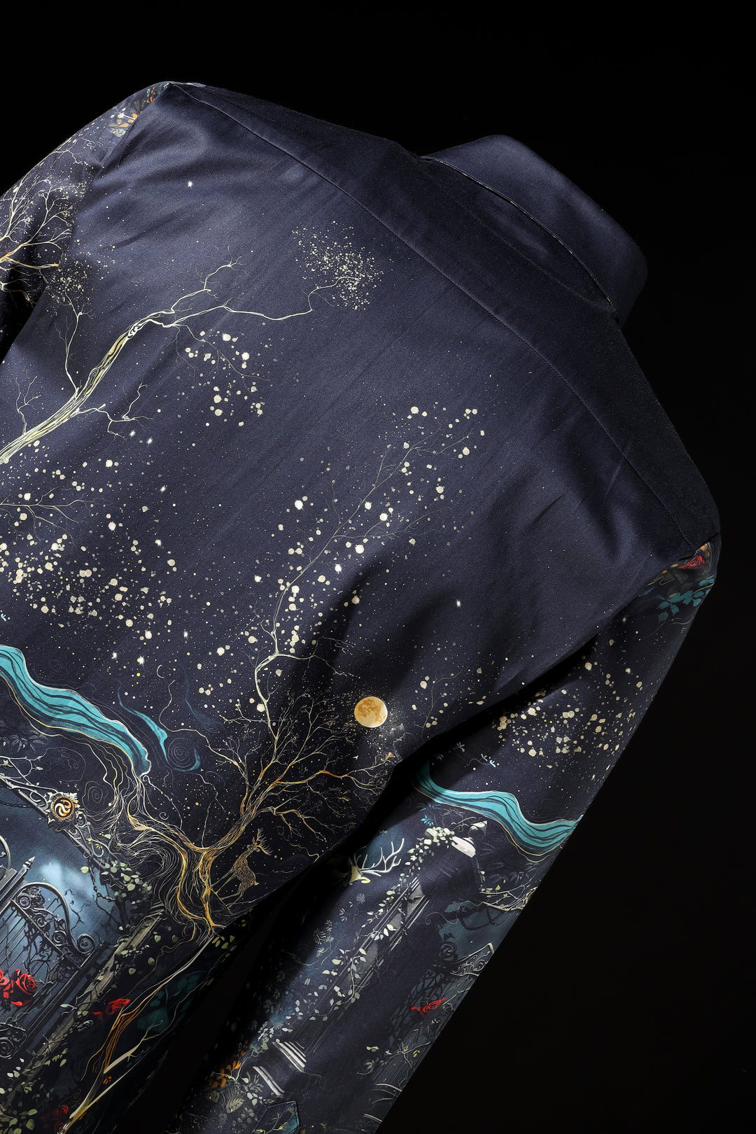 Navy blue garment with celestial design featuring stars and cosmic elements on a black background LoudLess