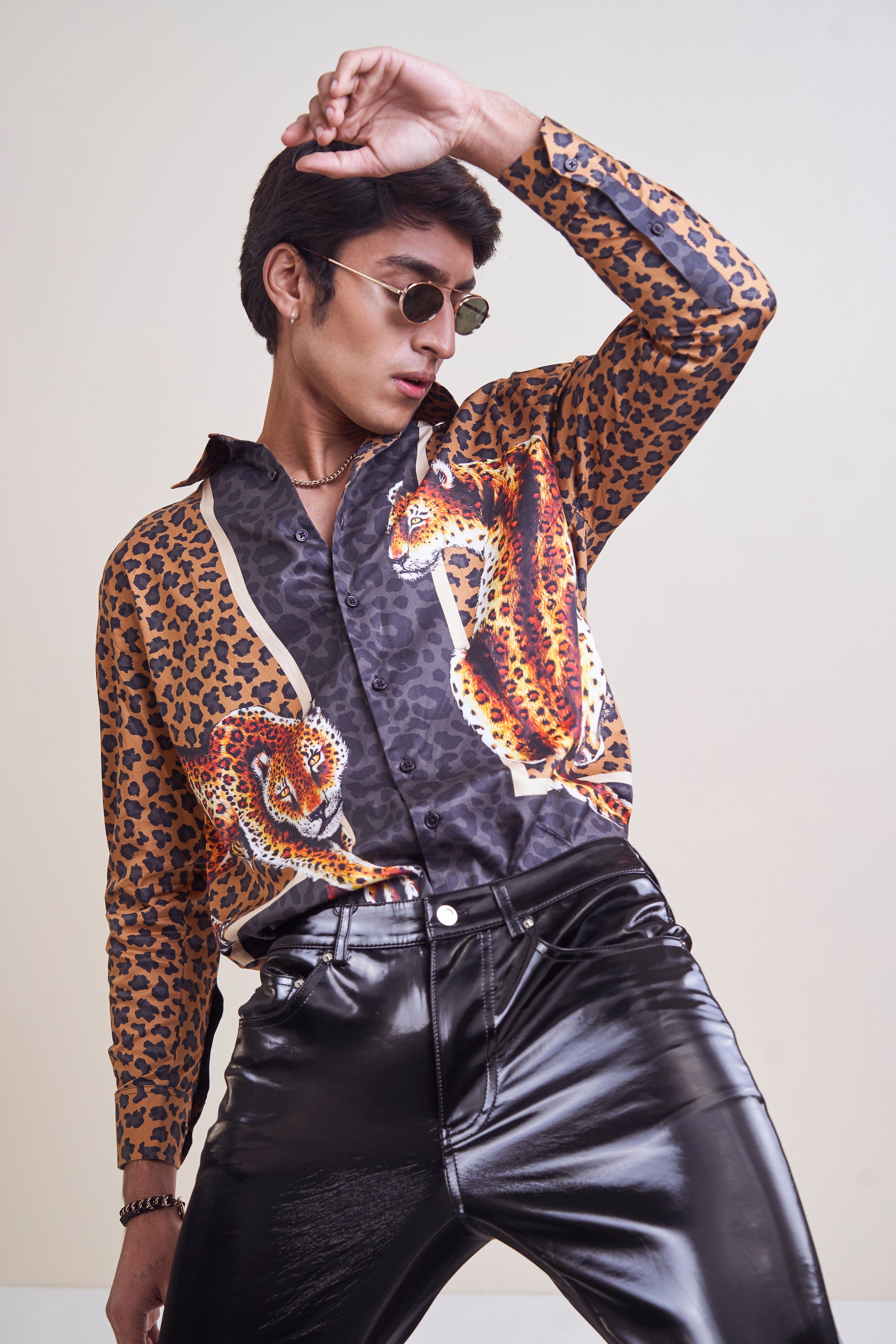 A luxurious leopard print shirt, featuring intricate detailing and high-end materials for a sophisticated and stylish look